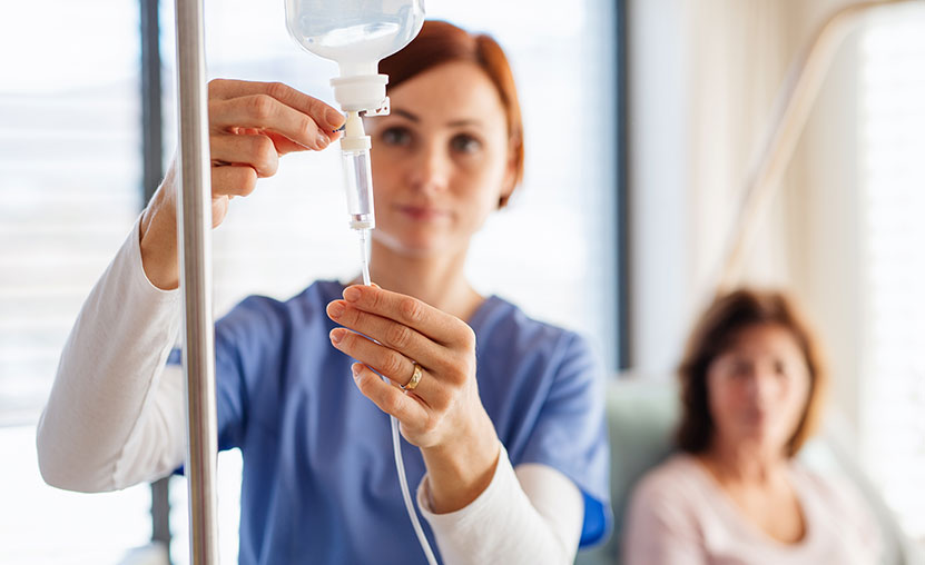 Nurse administering infusion therapy